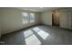 Large bedroom with neutral walls, plush gray carpet, and two windows that provide natural light at 128 Oat Grain Ct, Clayton, NC 27520