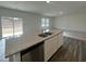The kitchen features a large center island and opens to the living area at 128 Oat Grain Ct, Clayton, NC 27520