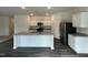 Open-concept kitchen featuring stainless steel appliances and a large center island at 128 Oat Grain Ct, Clayton, NC 27520
