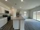 The kitchen features a center island, white cabinets, stainless appliances, and open layout at 128 Oat Grain Ct, Clayton, NC 27520