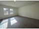 Large living room featuring carpeted floors and lots of natural light at 128 Oat Grain Ct, Clayton, NC 27520