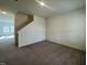 The room has carpet and leads to a staircase, offering a view of the home's interior at 128 Oat Grain Ct, Clayton, NC 27520