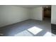 The living room is spacious with modern gray flooring and lots of natural light at 128 Oat Grain Ct, Clayton, NC 27520