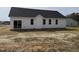 Rear exterior view showcasing windows and siding, providing ample natural light, with an expansive backyard at 164 Jones Creek Ln, Lillington, NC 27546