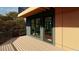 Spacious wood balcony with modern railings, views of the surrounding greenery, and large glass doors at 1709 Evergreen Ave, Raleigh, NC 27603