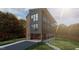 Contemporary three-story home with a neutral color palette, expansive windows, and covered parking at 1709 Evergreen Ave, Raleigh, NC 27603