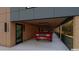 Well-lit garage featuring sleek concrete floors, wood ceiling, a red car, and an open design at 1709 Evergreen Ave, Raleigh, NC 27603