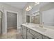 Modern bathroom with double vanity, quartz countertop, walk-in shower with glass door, and tiled floors at 1811 Parham Dr, Graham, NC 27253