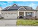 Charming single-Gathering home featuring a two-car garage, welcoming front porch, and attractive landscaping at 1811 Parham Dr, Graham, NC 27253