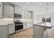 Well-equipped kitchen featuring granite countertops, stainless steel appliances, and ample cabinet space at 1811 Parham Dr, Graham, NC 27253