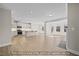 Open-concept living room and kitchen featuring hardwood floors, stainless steel appliances, and modern lighting at 1811 Parham Dr, Graham, NC 27253
