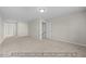 Bright living room features neutral walls, plush carpeting, and access to the staircase at 1811 Parham Dr, Graham, NC 27253