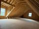 Unfinished attic space with exposed wooden beams and natural light at 187 Dairymont Dr, Pittsboro, NC 27312