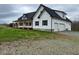 Charming white farmhouse with a covered porch and a two-car garage at 187 Dairymont Dr, Pittsboro, NC 27312