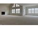 Open concept living room with high ceilings, fireplace, and large windows at 187 Dairymont Dr, Pittsboro, NC 27312