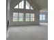 Spacious living room with high ceilings and large windows that allow plenty of natural light at 187 Dairymont Dr, Pittsboro, NC 27312