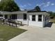 Side view of the charming house with a ramp leading to the entrance with well manicured grass at 200 Pace St, Smithfield, NC 27577