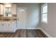 Kitchen area showcasing granite countertops, hardwood floors, and white cabinetry at 200 Pace St, Smithfield, NC 27577