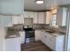 Well-lit kitchen with stainless steel appliances, ample counter space, and sleek white cabinets at 200 Pace St, Smithfield, NC 27577