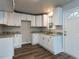 A kitchen featuring granite countertops, white cabinets and hardwood flooring at 200 Pace St, Smithfield, NC 27577