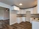 Kitchen features white cabinetry, stainless hardware, granite counters and modern lighting at 200 Pace St, Smithfield, NC 27577