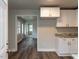 Bright kitchen with white cabinets and stainless steel hardware with views to connecting rooms at 200 Pace St, Smithfield, NC 27577