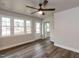 This living room shows a ceiling fan, hardwood floors, and large windows at 200 Pace St, Smithfield, NC 27577