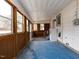 Sunroom featuring blue flooring, natural wood paneled framing, and an electrical box at 200 Pace St, Smithfield, NC 27577