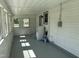 Enclosed sunroom with many windows to allow for sunlight and nice paint at 200 Pace St, Smithfield, NC 27577