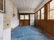 Sunroom featuring blue flooring and natural wood paneled framing at 200 Pace St, Smithfield, NC 27577