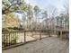 Large wooden back deck with black metal railings overlooking trees and backyard at 2015 Trident Maple Ln, Chapel Hill, NC 27517
