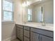 Bright bathroom featuring double sinks, quartz countertops, and a large mirror at 2015 Trident Maple Ln, Chapel Hill, NC 27517