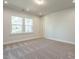 This airy bedroom features soft carpeting, two windows, neutral walls, and recessed lighting at 2015 Trident Maple Ln, Chapel Hill, NC 27517