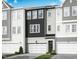 Modern townhome with black and white siding, attached garage and manicured landscaping at 2015 Trident Maple Ln, Chapel Hill, NC 27517