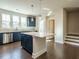 Bright kitchen features stainless steel appliances, blue cabinets, large island, and lots of natural light at 2015 Trident Maple Ln, Chapel Hill, NC 27517