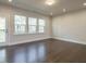 Living room featuring hardwood floors, recessed lights, and back patio access at 2015 Trident Maple Ln, Chapel Hill, NC 27517