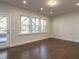 Bright living room with hardwood floors, recessed lighting, and multiple windows at 2015 Trident Maple Ln, Chapel Hill, NC 27517