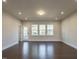 Bright living room featuring hardwood floors, recessed lights, and large windows at 2015 Trident Maple Ln, Chapel Hill, NC 27517