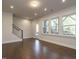 Well-lit living room featuring hardwood floors, recessed lights, and modern staircase at 2015 Trident Maple Ln, Chapel Hill, NC 27517