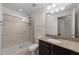 Bathroom offering a glass shower, a sink with granite countertops, and a wall mounted mirror at 222 Glenwood Ave # 608, Raleigh, NC 27603