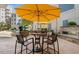 Cozy courtyard with patio furniture, fireplace, and yellow umbrellas at 222 Glenwood Ave # 608, Raleigh, NC 27603