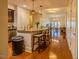 Kitchen leading to open-plan dining and living area with wood floors, island seating and modern appliances at 222 Glenwood Ave # 608, Raleigh, NC 27603