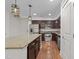 Open kitchen featuring stainless steel appliances, dark cabinets, granite countertops, and island with pendant lighting at 222 Glenwood Ave # 608, Raleigh, NC 27603