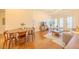 Living and dining area with open floor plan, wood floors, dining table, sofa and access to a balcony at 222 Glenwood Ave # 608, Raleigh, NC 27603