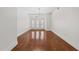 Bright living room with hardwood floors and french doors leading to balcony, offering a cozy atmosphere at 222 Glenwood Ave # 608, Raleigh, NC 27603