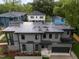 Aerial view of a modern home with gray siding and a black roof surrounded by mature trees at 2305 Turners Aly, Raleigh, NC 27607
