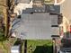 Aerial view showcases a home with a dark roof and concrete driveway, surrounded by a yard with grass and trees at 2305 Turners Aly, Raleigh, NC 27607