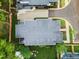 This aerial view captures the modern home's flat roof, concrete driveway, and lush landscaping on a verdant lot at 2305 Turners Aly, Raleigh, NC 27607