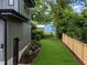 Well-maintained backyard with lush green lawn, modern gray siding, and privacy fence at 2305 Turners Aly, Raleigh, NC 27607