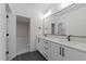 Modern bathroom with double sink vanity, sleek hardware, and dark tile flooring at 2305 Turners Aly, Raleigh, NC 27607